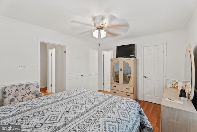 bedroom with wood-type flooring, ceiling fan, and crown molding