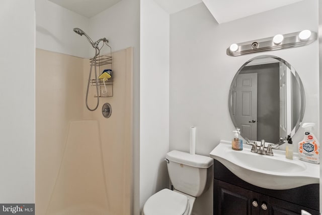 bathroom with a shower, vanity, and toilet