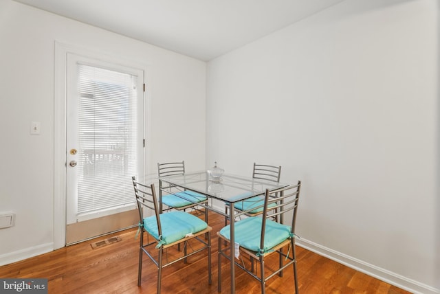 dining area featuring wood-type flooring