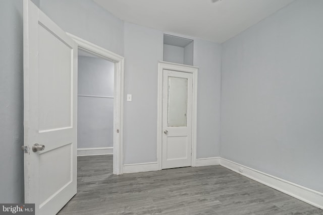 unfurnished bedroom with hardwood / wood-style flooring