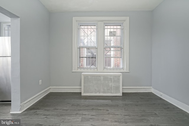 empty room featuring dark hardwood / wood-style flooring