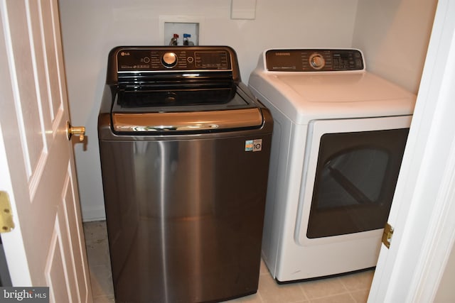 clothes washing area featuring independent washer and dryer