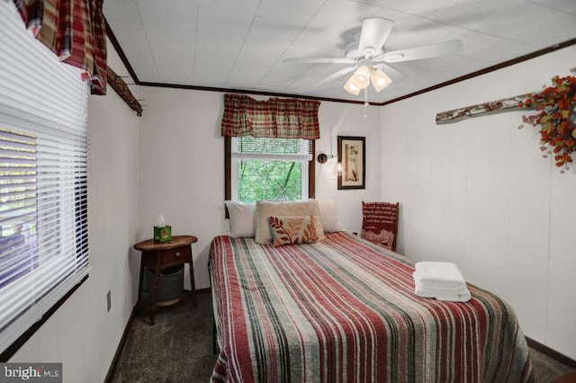 carpeted bedroom featuring ceiling fan and crown molding