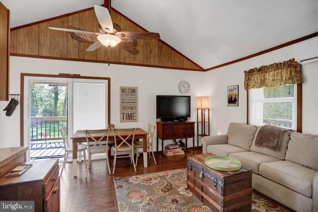 living room featuring high vaulted ceiling, plenty of natural light, and wooden walls