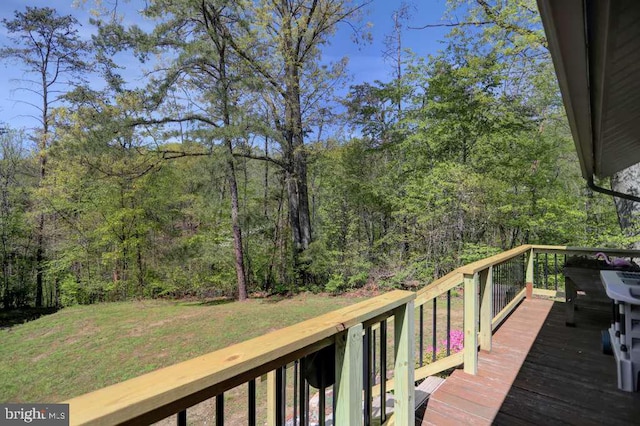 wooden terrace featuring a lawn