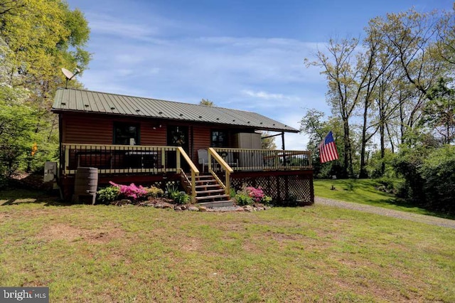 rear view of house with a yard and a wooden deck