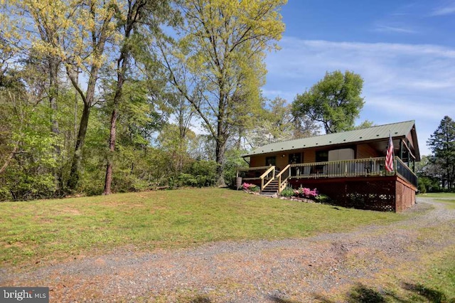 view of front of home featuring a front lawn and a wooden deck