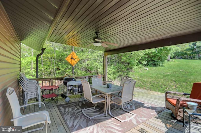 deck featuring a lawn and ceiling fan