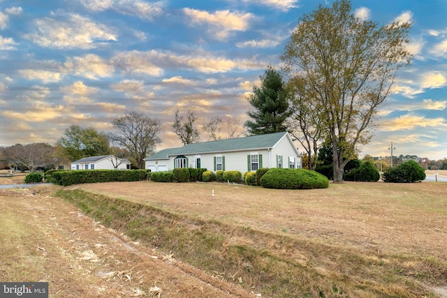 ranch-style house featuring a yard