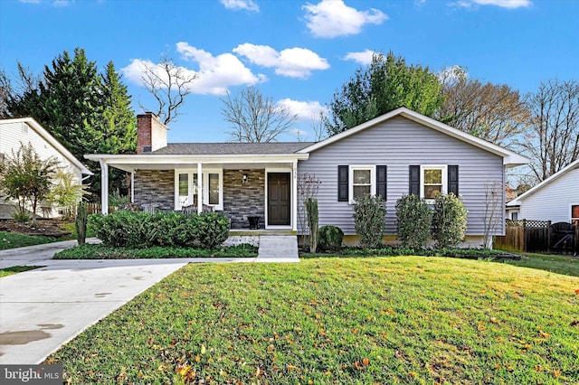 ranch-style home with covered porch and a front lawn