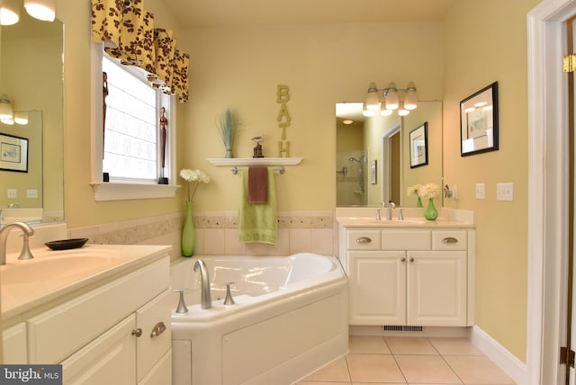 bathroom with tile patterned floors, vanity, and separate shower and tub