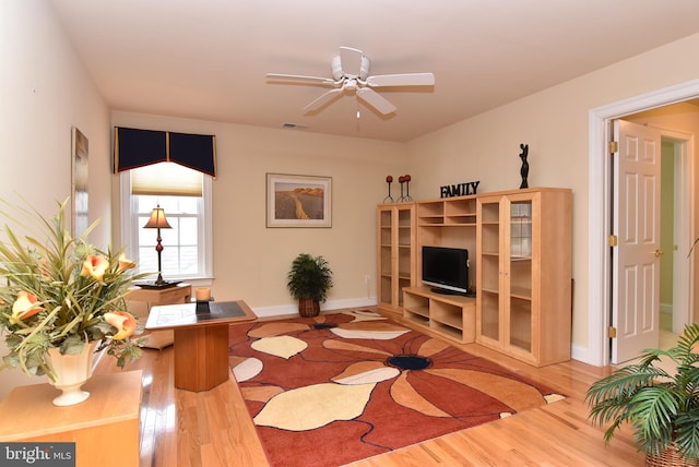 living room with hardwood / wood-style floors and ceiling fan