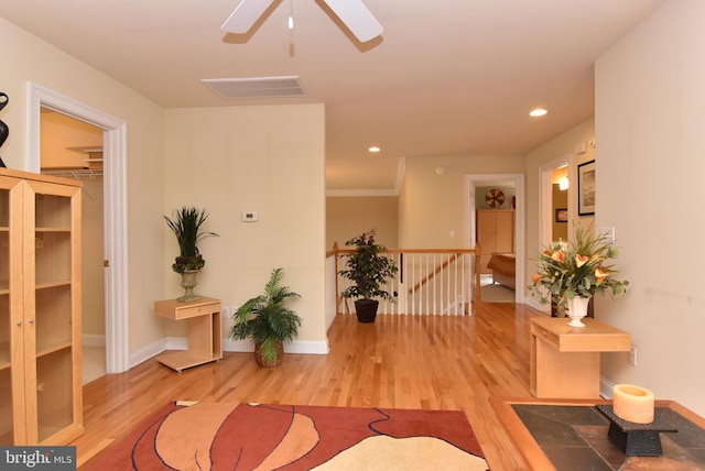 interior space with crown molding and light hardwood / wood-style flooring