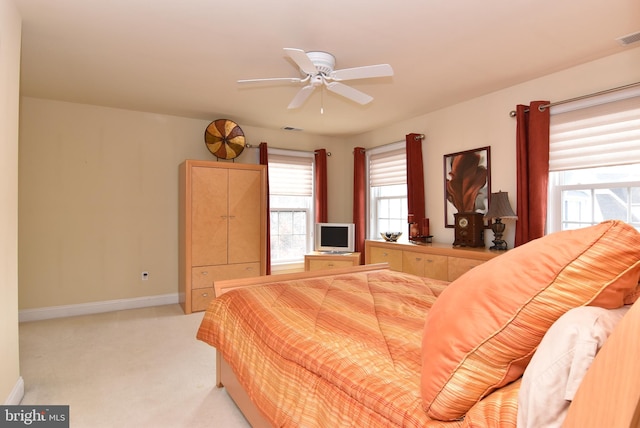 bedroom with ceiling fan and light colored carpet