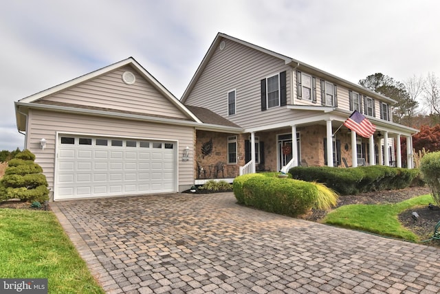 view of front of home featuring a porch and a garage