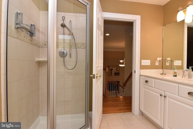 bathroom with tile patterned floors, vanity, and a shower with door