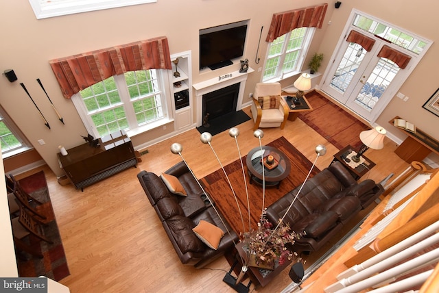 living room with a high ceiling and light hardwood / wood-style flooring