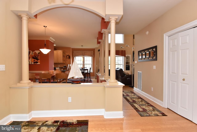 kitchen featuring light hardwood / wood-style floors, hanging light fixtures, and light brown cabinets