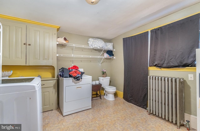 washroom with radiator heating unit and washer and clothes dryer