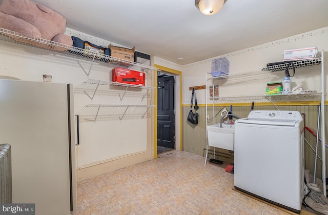 clothes washing area with washer / dryer and sink