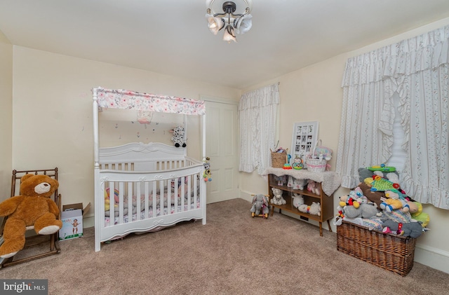 carpeted bedroom with a crib