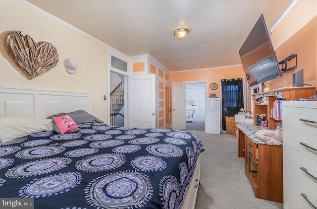 bedroom featuring light carpet, a closet, and ornamental molding