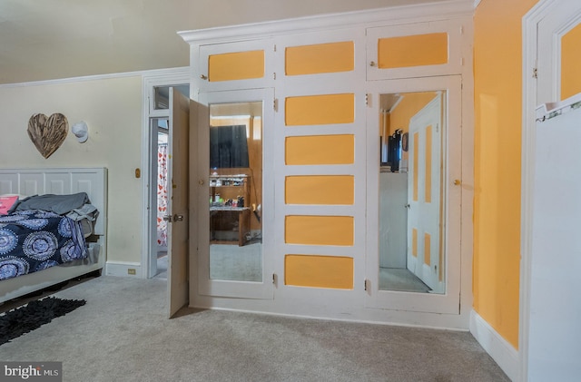 unfurnished bedroom featuring light carpet