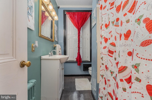 bathroom with walk in shower, vanity, crown molding, wood-type flooring, and toilet