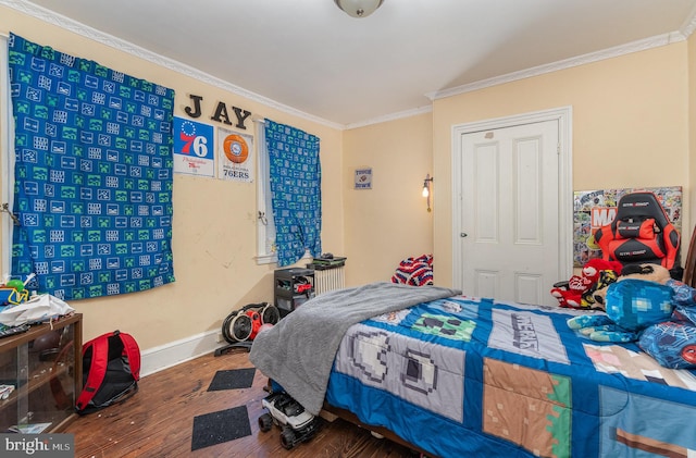 bedroom with hardwood / wood-style floors and ornamental molding