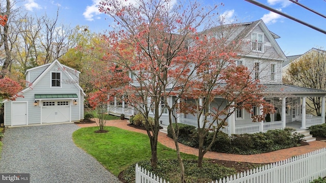 view of front of property with covered porch and a garage