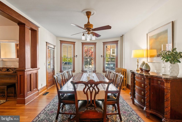 dining area with ceiling fan and light hardwood / wood-style floors