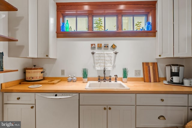 kitchen featuring dishwasher, white cabinets, butcher block countertops, and sink