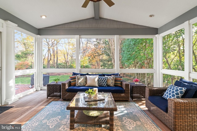 sunroom / solarium with lofted ceiling with beams, ceiling fan, and a healthy amount of sunlight