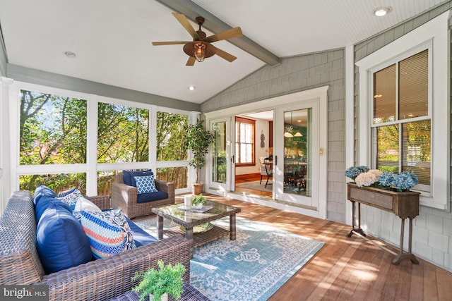 sunroom / solarium with vaulted ceiling with beams, ceiling fan, and a healthy amount of sunlight