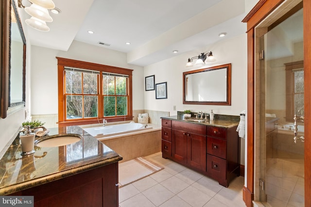 bathroom with tile patterned floors, vanity, and independent shower and bath