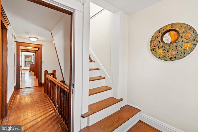 stairs with wood-type flooring