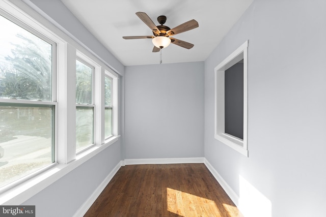 unfurnished sunroom with ceiling fan