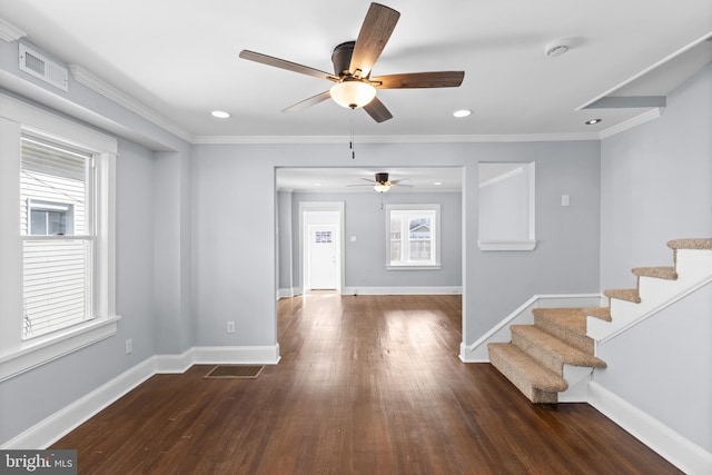 foyer featuring ceiling fan, plenty of natural light, dark hardwood / wood-style floors, and ornamental molding