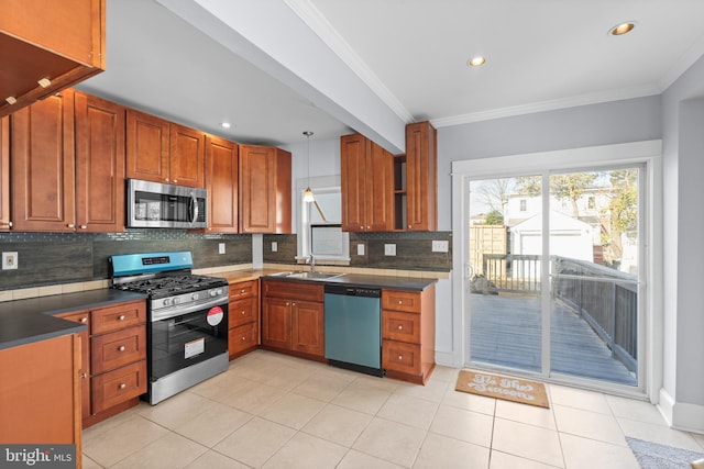 kitchen featuring backsplash, ornamental molding, sink, and appliances with stainless steel finishes