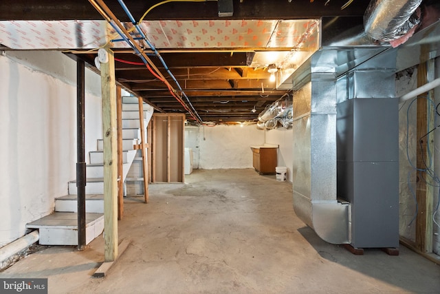 basement featuring washer / dryer and heating unit