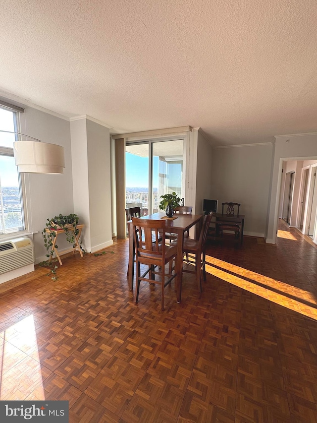 dining area with crown molding, dark parquet flooring, a textured ceiling, and a wall mounted AC