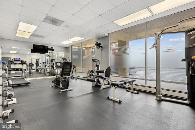 gym with a paneled ceiling