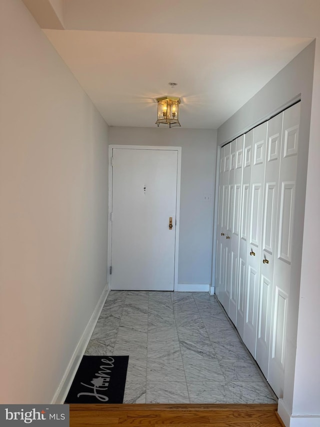 corridor with a notable chandelier