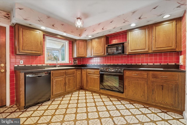 kitchen with black appliances, decorative backsplash, a raised ceiling, and sink