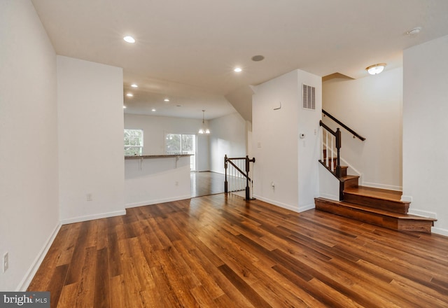 unfurnished living room with dark hardwood / wood-style flooring