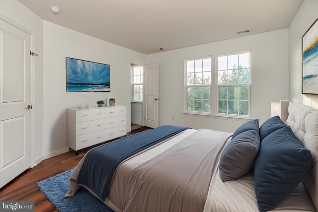 bedroom with dark wood-type flooring