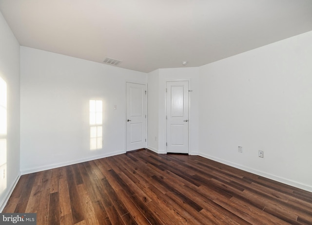 empty room with dark wood-type flooring