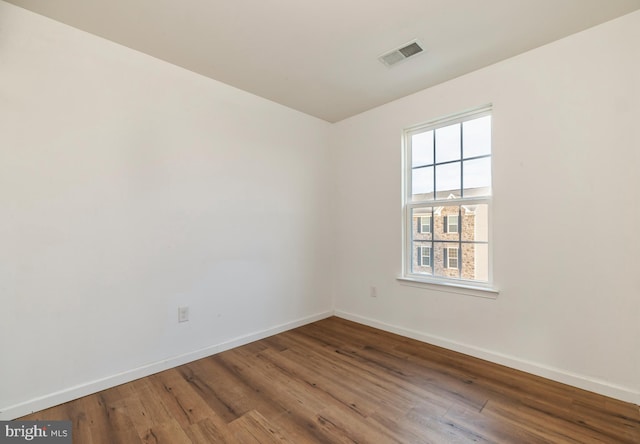 spare room with wood-type flooring