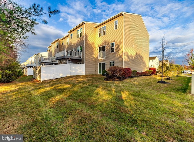 rear view of house featuring a yard