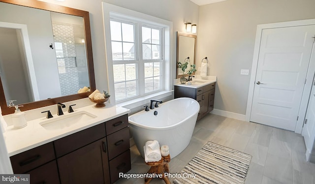 bathroom featuring plus walk in shower, vanity, and tile patterned floors